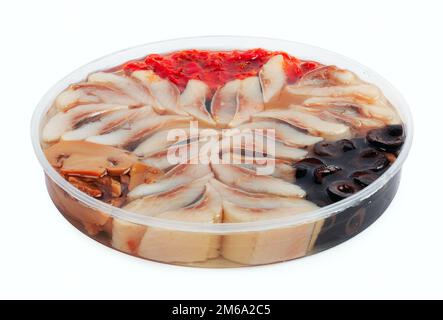 Slices of marinated herring with mushrooms and black olives Stock Photo