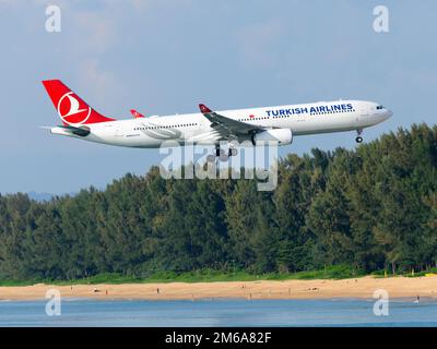 Turkish Airlines Airbus A330-300 aircraft over Mai Khao Beach. Airplane A330 of Turkish over Phuket Airport Beach. Plane above beach. Stock Photo