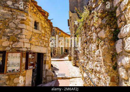 Eze, France - August 1, 2022: Historic streets and stone houses in medieval town of Eze on French Riviera Coast of Mediterranean Sea Stock Photo