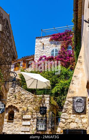 Eze, France - August 1, 2022: Historic streets and stone houses in medieval town of Eze on French Riviera Coast of Mediterranean Sea Stock Photo