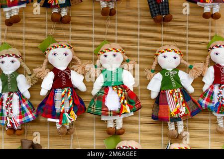 Cute handmade ragdoll dolls in Lithuanian national costumes sold on Easter market in Vilnius. Lithuanian capitals annual traditional crafts fair is he Stock Photo