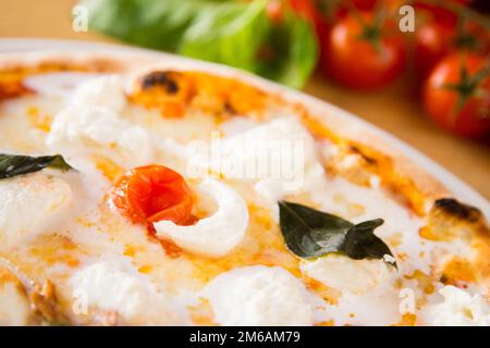 Bufala Mozzarella Pizza. Neapolitan pizza made with tomato sauce, mozzarella cheese and some vegetables. Italian recipe. Stock Photo