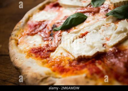 Bufala Mozzarella Pizza. Neapolitan pizza made with tomato sauce, mozzarella cheese and some vegetables. Italian recipe. Stock Photo