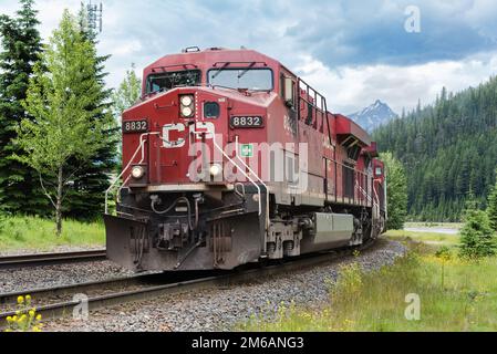 Field, BC, Canada - June 23, 2016; Canadian Pacififc freight train closeup on curve with red engine Stock Photo