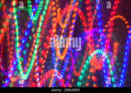 Abstract pattern of bouncing beads as colorful lights in vertical zig zag motion Stock Photo