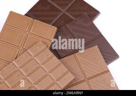 KYIV, UKRAINE - MAY 4, 2022 Lindt Swiss luxury brand chocolate brown tablets with embossed original company logo. Stock Photo