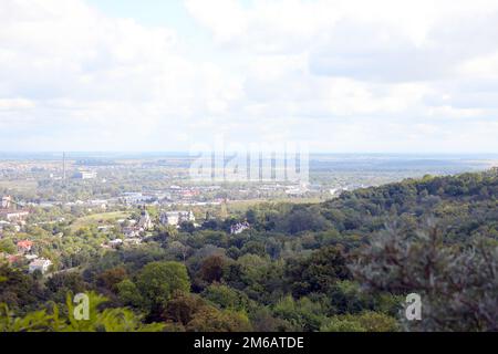 LVIV, UKRAINE - SEPTEMBER 11, 2022 Panorama view of the historical old city in Lviv, Ukraine. Many old buildings with metal roofs and cathedral domes in beginning of autumn day Stock Photo