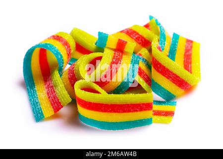 rainbow sour jelly candies strips in sugar sprinkle on white background. Stock Photo