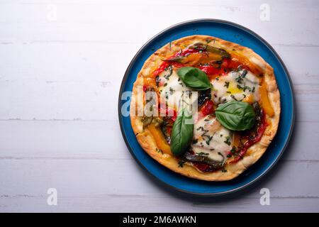 Pizza with paprika. Neapolitan pizza made with baked vegetables. Italian vegetarian recipe. Stock Photo