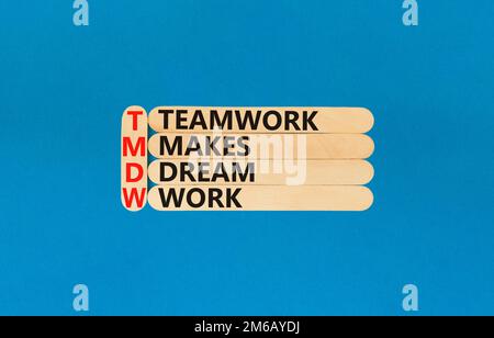 TMDW Teamwork makes dream work symbol. Concept words TMDW Teamwork makes dream work on wooden stick on beautiful blue background. Business TMWD teamwo Stock Photo