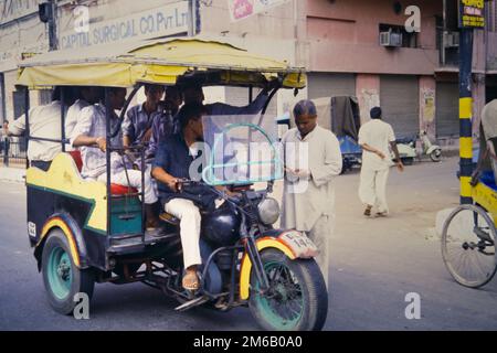 A modified auto-rickshaw carrying passengers in Rajgir, Bihar, India ...