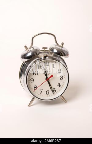 Metal alarm clock with mechanical clockwork and bell mechanism Stock Photo