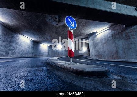 Driveway in underground car park with traffic sign at night, Pforzheim, Germany Stock Photo