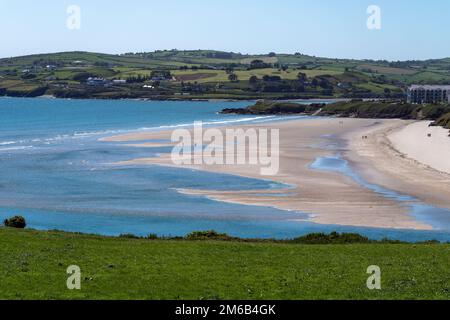 Inchydoney sandy beach at low tide on a sunny spring day. The famous Irish beach on the south coast of the country. Seaside landscape. Stock Photo