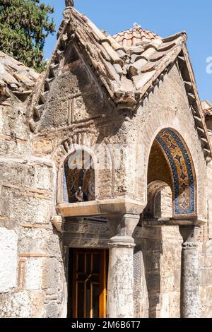 Holy Church of the Presentation of the Virgin Mary - Panagia Kapnikarea, Athens, Greece. Detail showing a pigeon sitting in an alcove above the door. Stock Photo