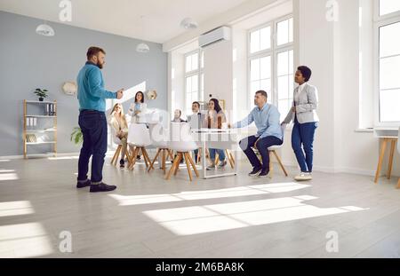 Corporate manager talking to a diverse business team during a meeting in the office Stock Photo