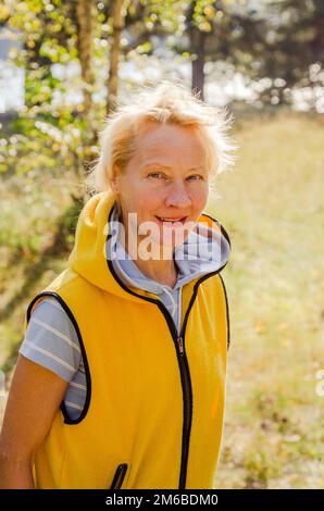 Portrait of a middle-aged woman in a park on a sunny day Stock Photo