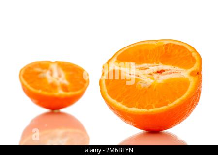 Two halves of sweet organic tangerine, macro, isolated on white background. Stock Photo