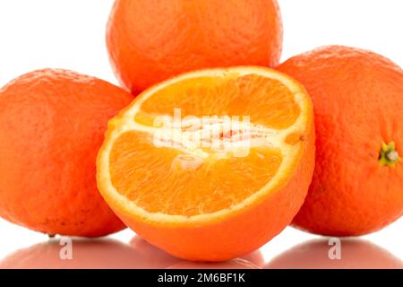 One half and three whole sweet organic tangerines, macro, isolated on white background. Stock Photo