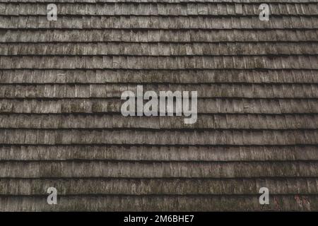 gray weathered wood wall shingles textured background with uniformity horizontal lines from a shingled roof or outdoor weathered wall. Stock Photo