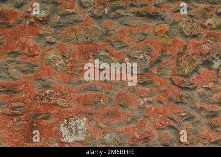 Horizontal stoned rock cobble stone wall red mortar for a textured background abstract material that is slightly dirty vintage and grunge non-uniform Stock Photo