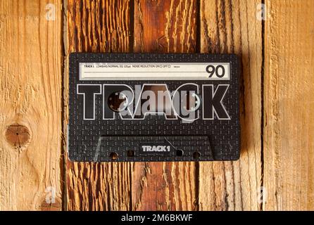 Audio cassette tape on old wooden background