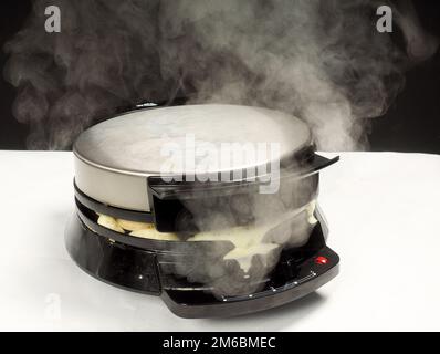 Steaming hot waffle maker Stock Photo
