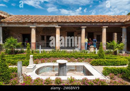 House in Pompeii near Naples, Italy. Pompeii is Ancient Roman city, World landmark. Scenery of patio with landscaped garden of wealthy home. Theme of Stock Photo