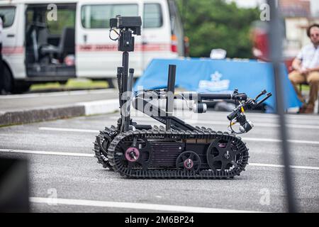 A Foster-Miller TALON robot is operated by families during the Headquarters and Support Battalion Family Day event on Camp Foster, Okinawa, Japan, on April 22, 2022. Family Day allowed service members to engage in activities with their children, allowing them to view military vehicles, participate in a mock combat fitness test, and learn professional training from the Marine Corps Martial Arts Program and the Marksmanship Training Unit. Stock Photo