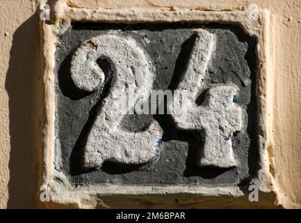 Old retro weathered cast iron plate with number 24 Stock Photo