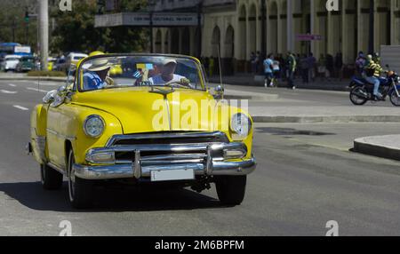 American yellow Cabriolet classic car drives in Havana Cuba - Serie Cuba Reportage Stock Photo
