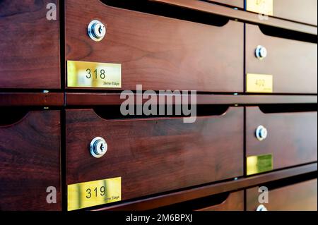 Wooden Mailboxes in the entrance hall of a residential house Stock Photo