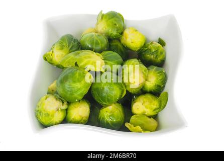 White designer bowl with fresh green brussel sprouts isolated on white Stock Photo