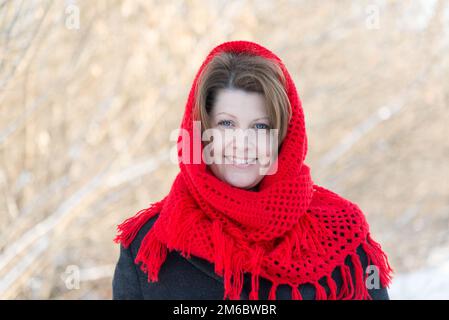 Russian woman with red knitted shawl outdoors Stock Photo