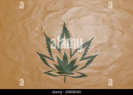 Brown parcel packaging paper printed with a cannabis leaf icon. Illustration of illegal weed delivery and social issues brought from marijuana Stock Photo