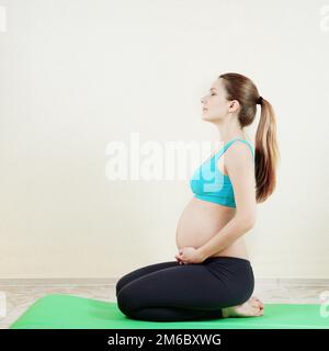 Pregnant woman in action Stock Photo