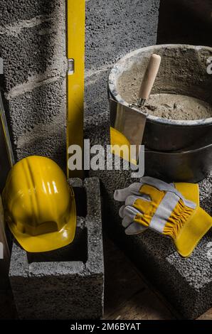 Tools for bricklayer bucket with a solution and a trowel, close- Stock Photo
