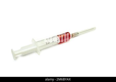 Syringe with a drop of blood isolated on white background Stock Photo