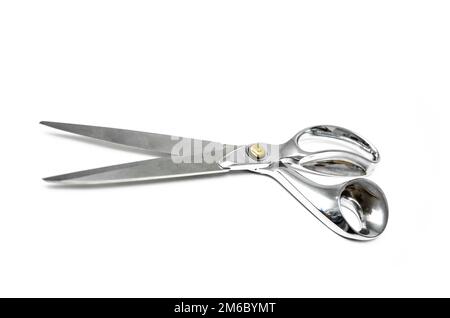 Pair of tailor scissors with metal golden handle isolated on white background. Stock Photo