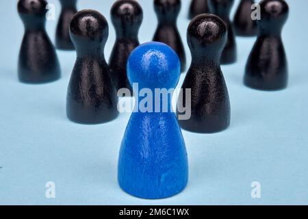 Symbol for leadership with game figures in blue and black Stock Photo