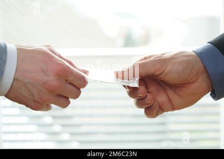 Closeup of businesspeople exchanging business card Stock Photo by BGStock72