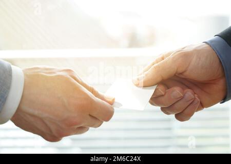 Businesspeople exchanging Visiting Card In Office with sunshine Stock Photo