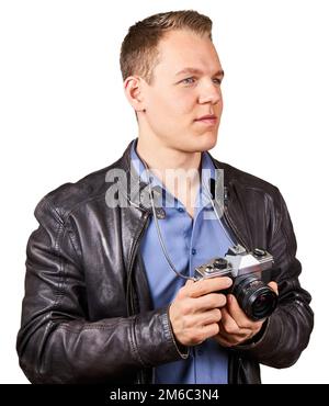 Handsome young man with a leather jacket holding a vintage camera. Isolated Stock Photo