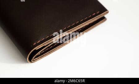 Details of brown elegance men's leather wallet on a white background. Mens leather accessories. Natural leather. Stock Photo