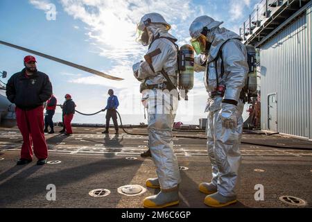 At Sea. 29th Dec, 2022. Sailors assigned to the Ticonderoga-class guided-missile cruiser USS Leyte Gulf (CG 55) prepare to rescue personnel during an aircraft firefighting drill, Dec. 22, 2022. The George H.W. Bush Carrier Strike Group is on a scheduled deployment in the U.S. Naval Forces Europe area of operations, employed by U.S. Sixth Fleet to defend U.S., allied, and partner interests. Credit: Christine Montgomery/U.S. Navy/ZUMA Press Wire Service/ZUMAPRESS.com/Alamy Live News Stock Photo