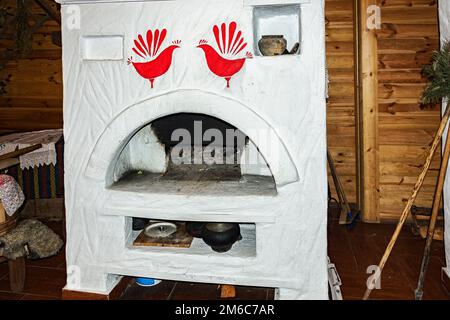 Russian stove without fire in the Russian hut Stock Photo