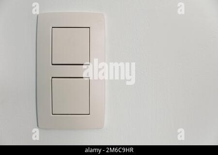 Standard double switch on a white wall, for use at home Stock Photo