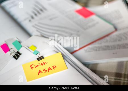 Finish ASAP; Stack of Documents with Large Amount of Analytic Material. Stock Photo