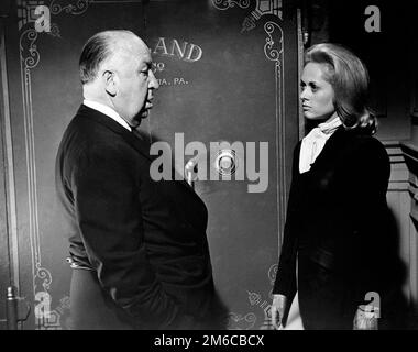 Alfred Hitchcock and Tippi Hedren at set for 'Marnie' (1964) Alfred Hitchcock and Tippi Hedren at set for 'Marnie' (1964) Stock Photo