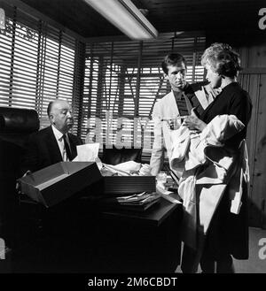 Alfred Hitchcock with Anthony Perkins and Janet Leigh while filming Psycho, 1954 - publicity photo Stock Photo